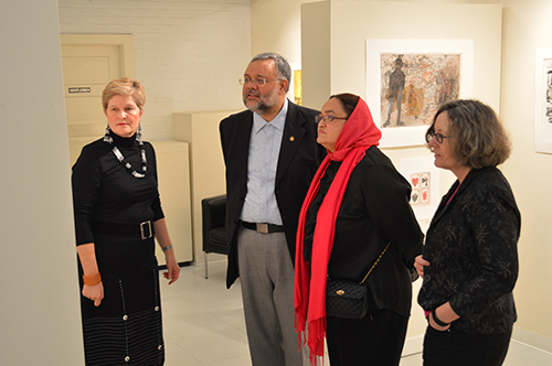 Anne Gordon, Executive Director of Vula Amehlo Art Development (far left), provides a tour of the exhibition to South African Ambassador to the United States Ebrahim Rasool (second from left); to Ambassador Rasool's wife Roseida Shabodien (third from left); and to Christine Mullen Kreamer, Deputy Director and Chief Curator of the Smithsonian National Museum of African Art (far right).